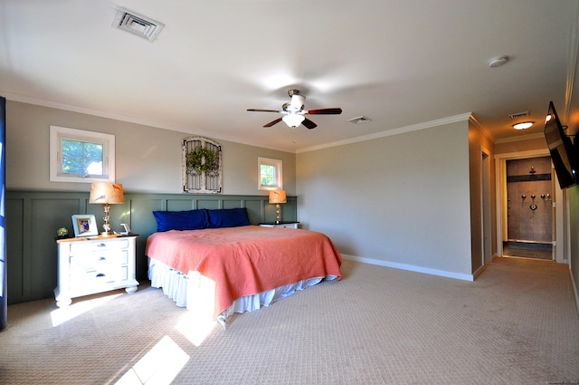 bedroom featuring visible vents, crown molding, and light colored carpet