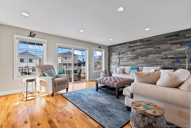 living room featuring wood walls and light wood-type flooring