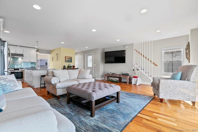 living room with light hardwood / wood-style flooring and a healthy amount of sunlight