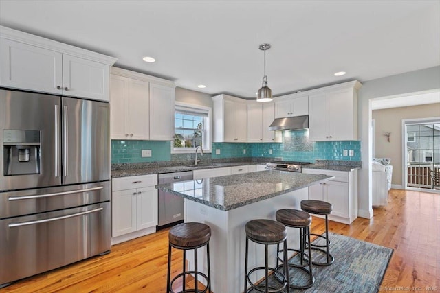 kitchen featuring sink, decorative light fixtures, white cabinets, and appliances with stainless steel finishes