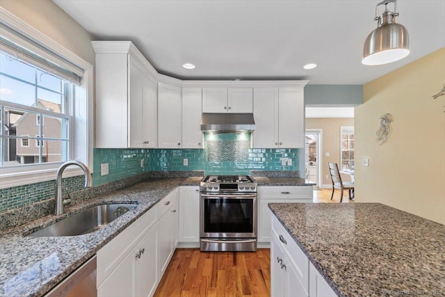 kitchen featuring stainless steel appliances, sink, and white cabinets