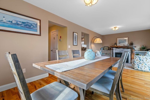 dining space with hardwood / wood-style floors