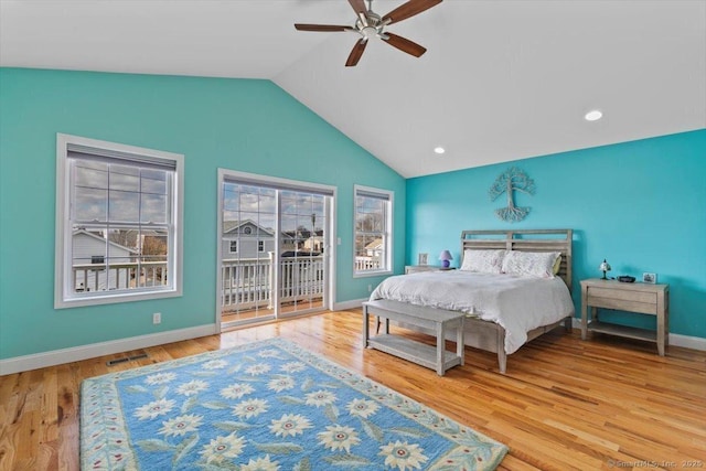 bedroom featuring multiple windows, access to exterior, and hardwood / wood-style floors