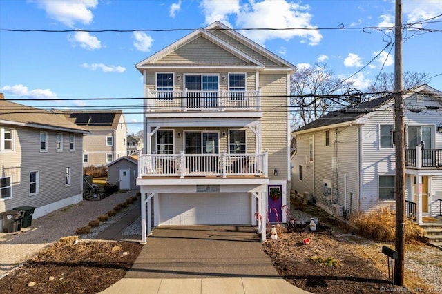 view of front facade with a garage and a balcony