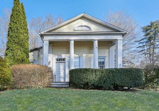 greek revival house with entry steps and a front yard