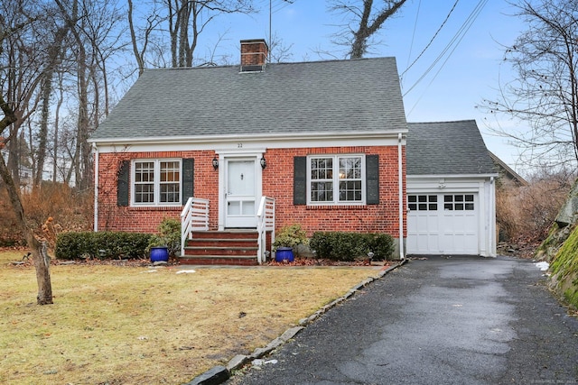 cape cod-style house featuring a garage and a front lawn