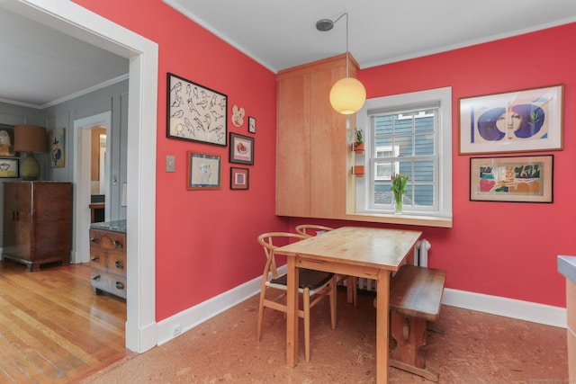 dining space with crown molding and baseboards