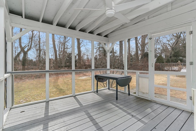 sunroom with lofted ceiling and a ceiling fan