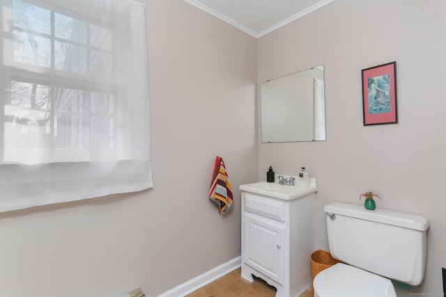 bathroom with toilet, baseboards, ornamental molding, and vanity