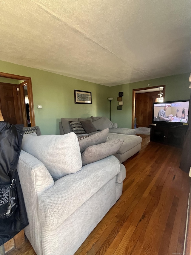 living room with hardwood / wood-style flooring and a textured ceiling