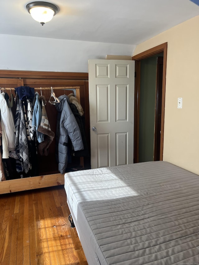 bedroom with dark hardwood / wood-style flooring