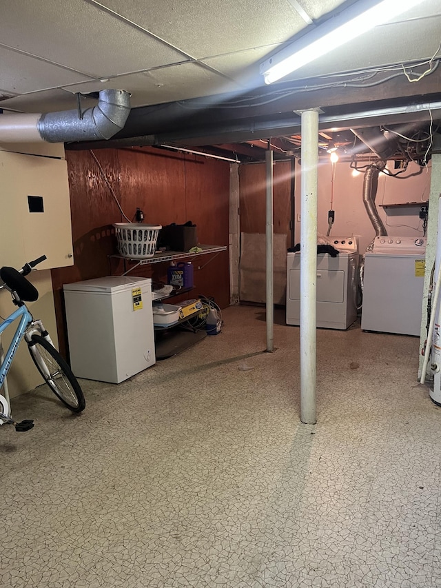 basement featuring separate washer and dryer and refrigerator