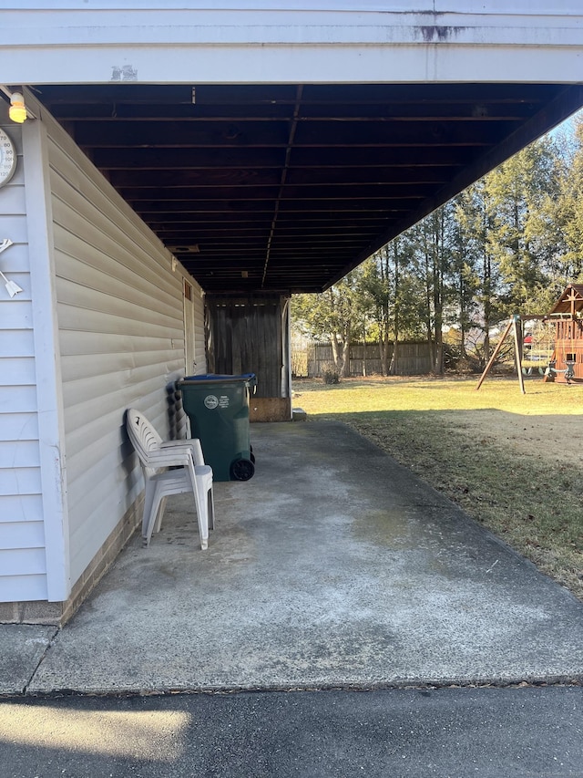 view of parking featuring a yard and a playground