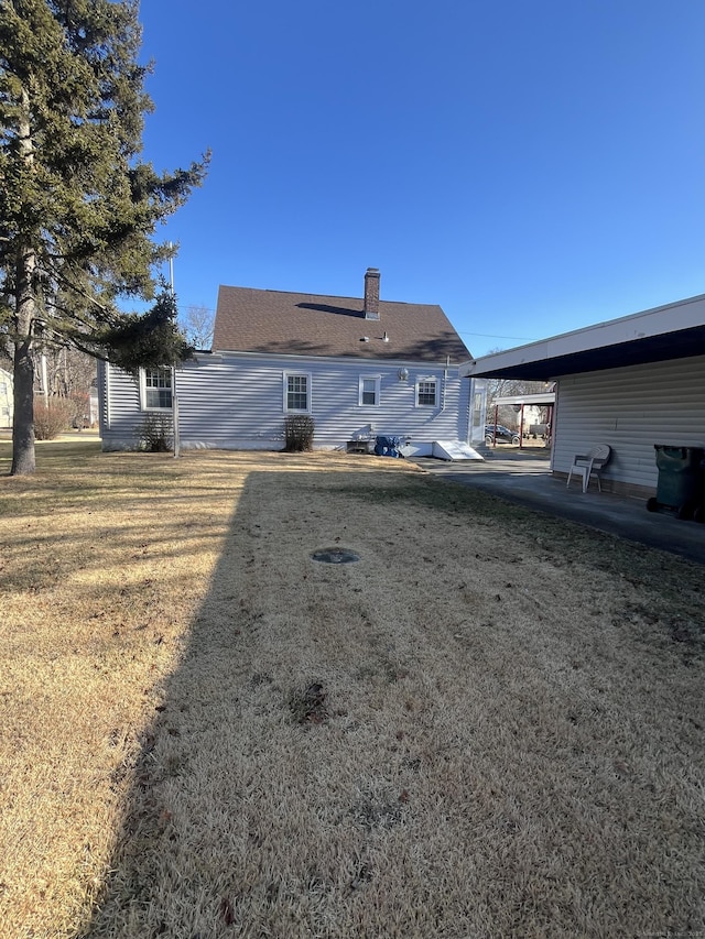 rear view of house featuring a lawn