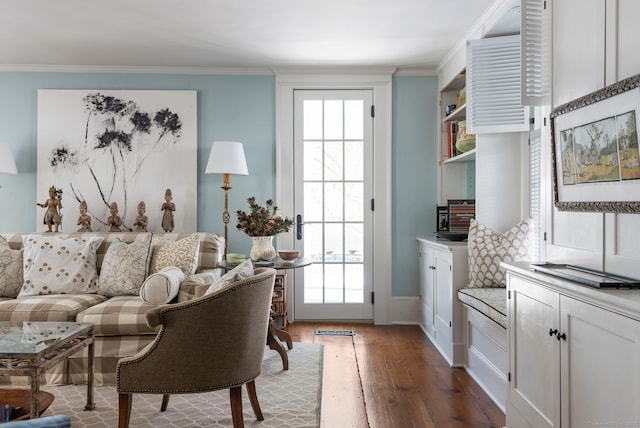 living room with ornamental molding, a healthy amount of sunlight, and hardwood / wood-style floors