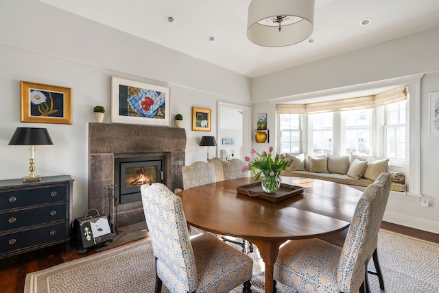 dining room featuring dark hardwood / wood-style floors and a premium fireplace