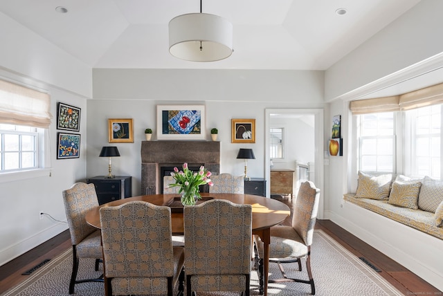 dining room featuring vaulted ceiling and hardwood / wood-style floors