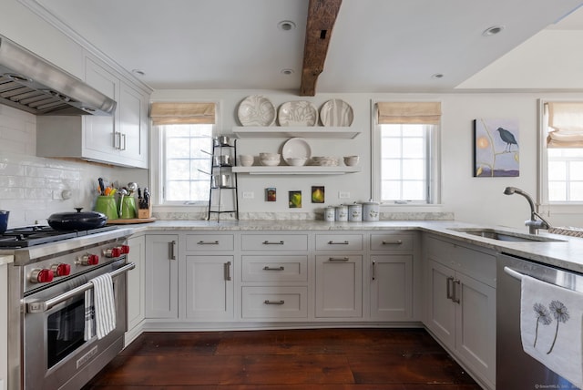 kitchen featuring extractor fan, appliances with stainless steel finishes, white cabinetry, sink, and a healthy amount of sunlight