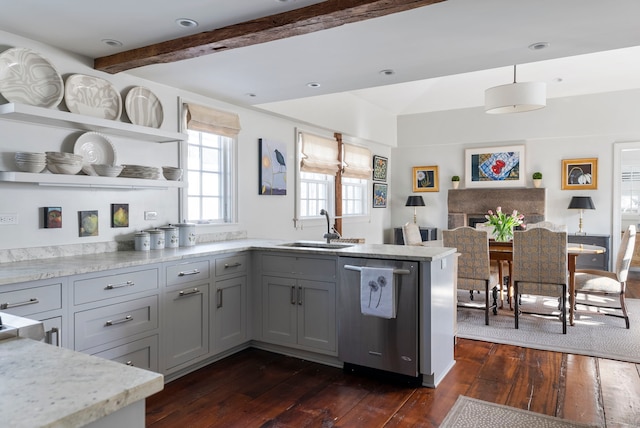 kitchen featuring sink, gray cabinetry, dark hardwood / wood-style flooring, decorative light fixtures, and stainless steel dishwasher