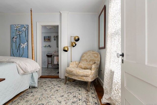 bedroom featuring ornamental molding and hardwood / wood-style floors