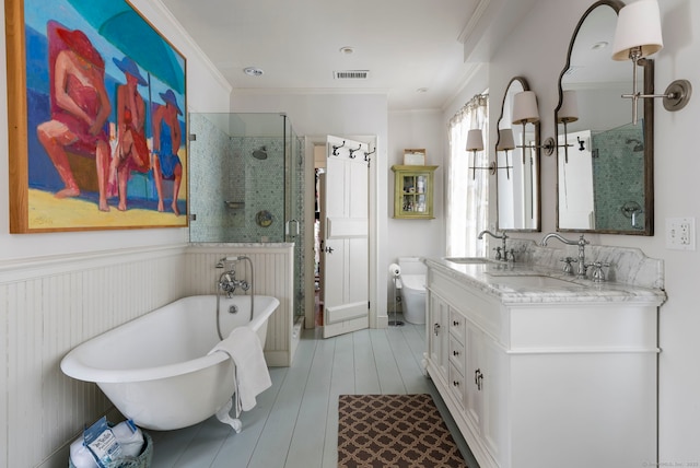 full bathroom featuring vanity, hardwood / wood-style floors, crown molding, and toilet