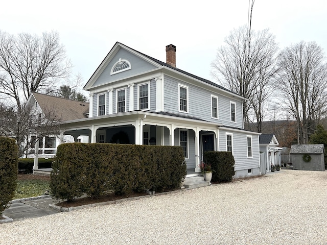 view of front facade featuring a storage unit