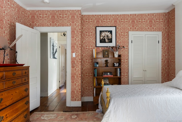 bedroom with ornamental molding, hardwood / wood-style floors, and a closet