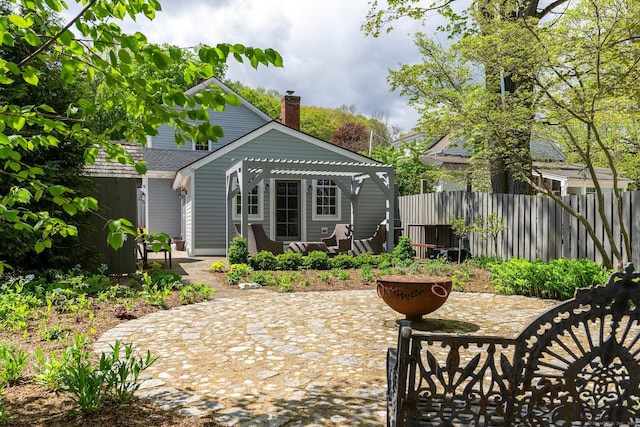 4 Main St, Salisbury, CT 06068 - rear view of property featuring a pergola, a patio area, and a chimney