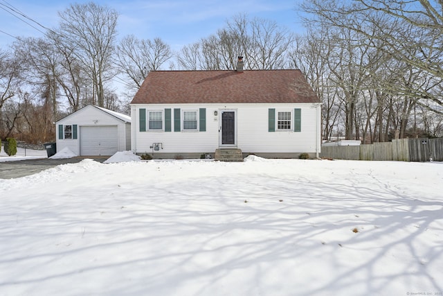 view of front of house with a garage and an outbuilding