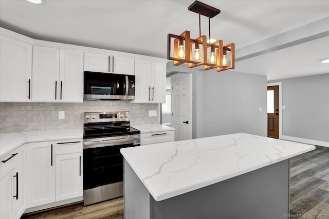 kitchen with a kitchen island, white cabinetry, appliances with stainless steel finishes, and pendant lighting