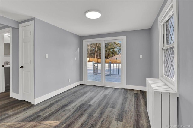 unfurnished room with dark wood-type flooring