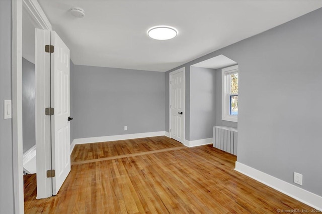 bonus room with radiator and light hardwood / wood-style floors