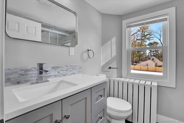 bathroom featuring vanity, radiator, and toilet