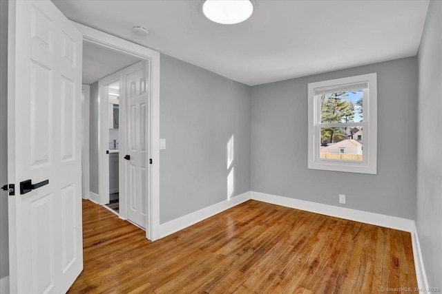 spare room with wood-type flooring