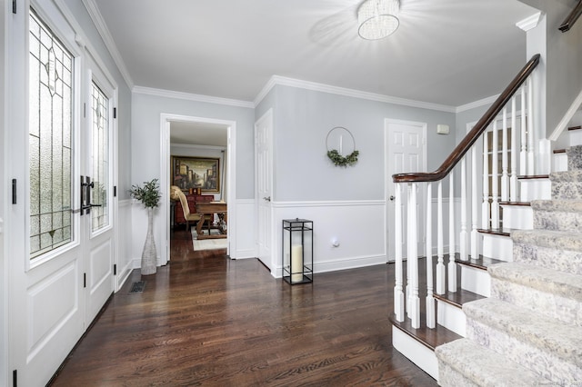 entrance foyer featuring dark wood-type flooring and ornamental molding