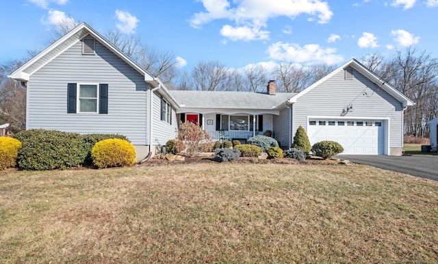 view of front of property with a garage, covered porch, and a front yard