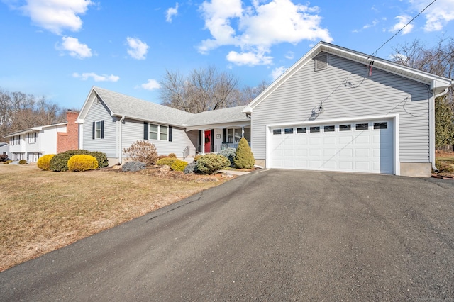 view of front of property with a garage and a front lawn