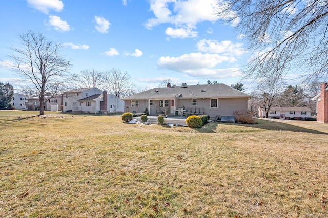 rear view of property with a yard