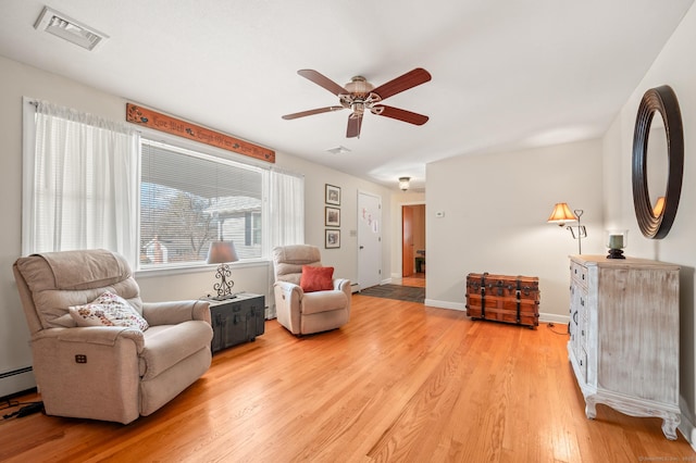 sitting room featuring ceiling fan and light wood-type flooring