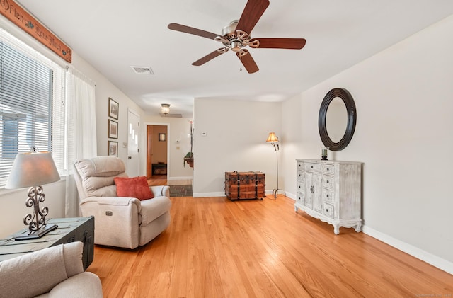 living room with ceiling fan and light hardwood / wood-style floors