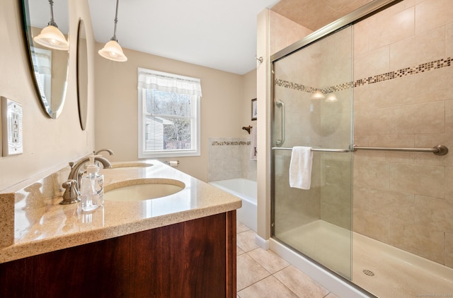 bathroom with tile patterned flooring, vanity, and separate shower and tub