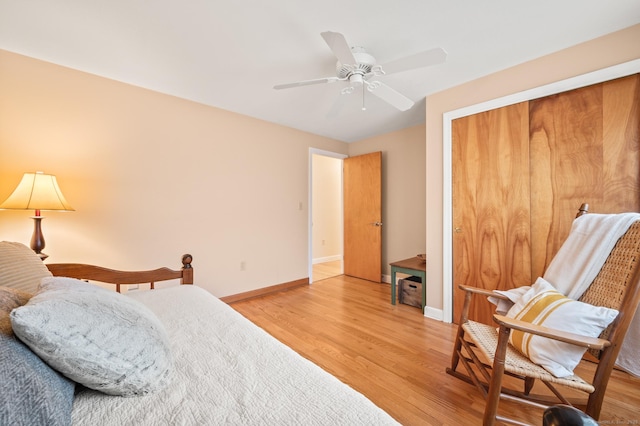 bedroom with hardwood / wood-style flooring, ceiling fan, and a closet