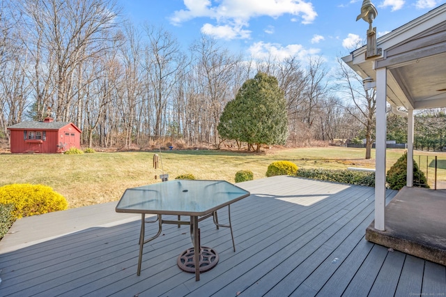 deck with a lawn and a storage unit