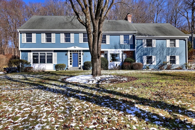 colonial inspired home featuring a yard