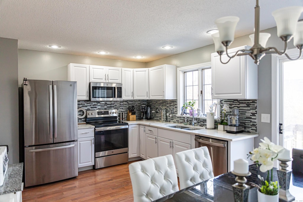 kitchen with sink, white cabinets, and appliances with stainless steel finishes