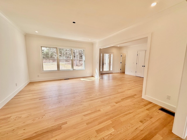 unfurnished living room with crown molding and light hardwood / wood-style floors