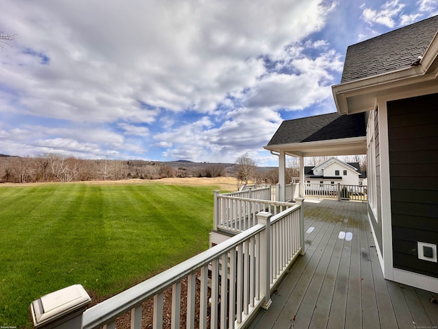 wooden terrace featuring a yard