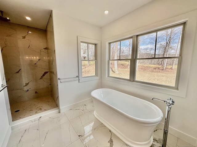 bathroom featuring independent shower and bath