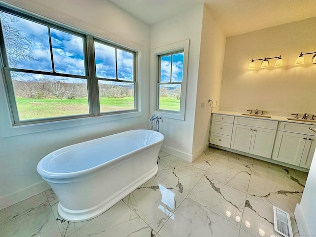 bathroom with vanity and a bath