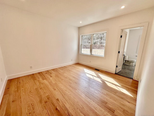 empty room with light hardwood / wood-style flooring